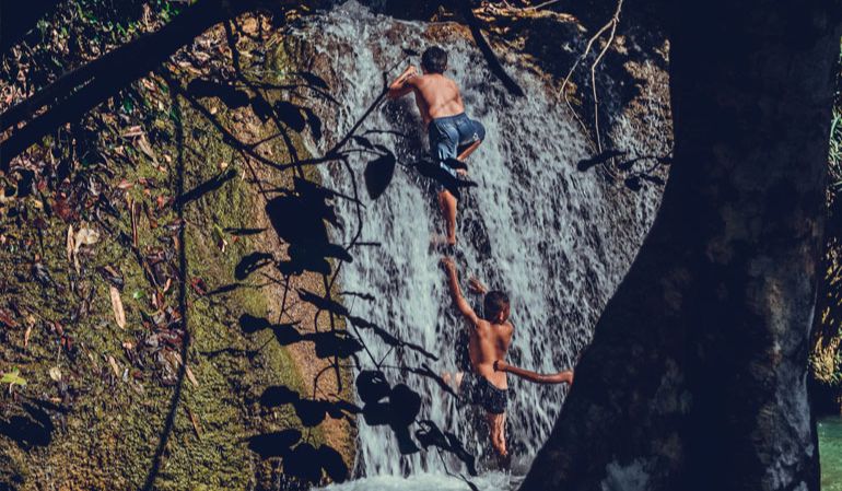 kids play at the waterfalls